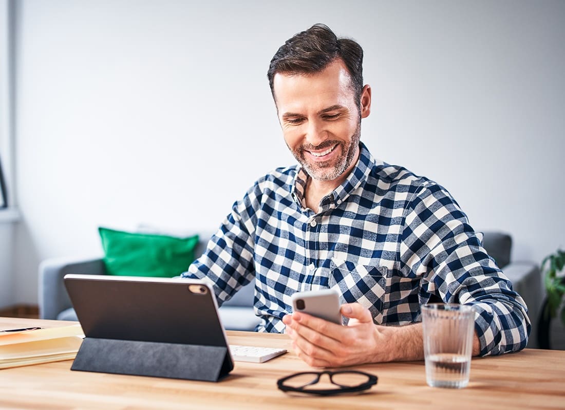 Contact - Man Checking His Smartphone While Working From Home